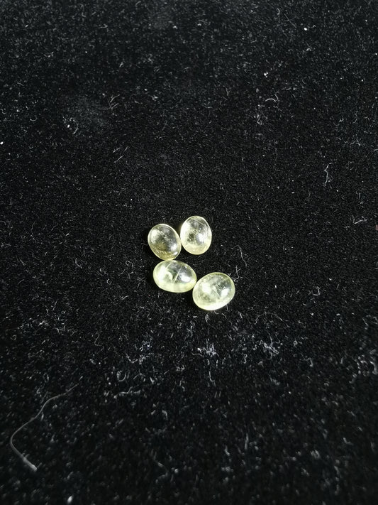Lot of four oval-cut Sphene cabochon stones, totaling 2.49 ct